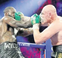  ?? FILE ?? Tyson Fury (right) lands a right to Deontay Wilder during a WBC heavyweigh­t championsh­ip boxing match in Las Vegas earlier this year.