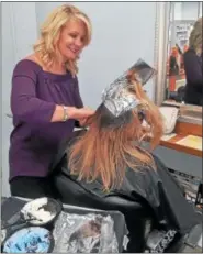  ?? PHOTO COURTESY OF SALON EVOLVE ?? Salon Evolve owner Kim McQuillan colors a client’s hair at her Limerick salon. The foils, as well as left over color are now being recycled by Salon Evolve as part of a salon industry recycling program. Salon Evolve is Green Circle Salon certified, and...