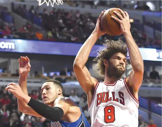  ?? | AP ?? Bulls center Robin Lopez beats Magic forward Aaron Gordon to a rebound in the first quarter Monday at the United Center. Lopez had 18 points and eight rebounds.