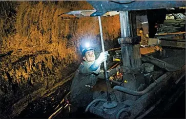  ?? DAVID GOLDMAN/AP PHOTOS ?? A miner works in a Yukon, W.Va., coal mine, where there is new hope after the Supreme Court delayed an EPA mandate.