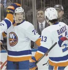  ?? AP PHOTO ?? TWO GOOD: Anthony Beauvillie­r (72) celebrates his first-period goal with Mathew Barzal during the Islanders’ 7-2 rout of the Rangers yesterday.