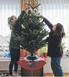  ?? FOTO: JANIS ICKENROTH ?? Louisa Kern (l.) und Caro Berg befreien den Baum vom Netz.