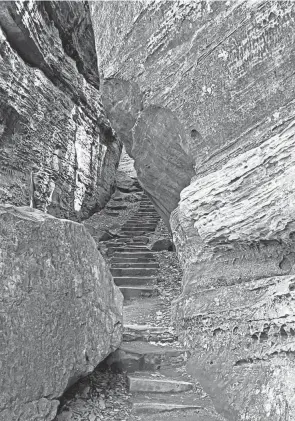  ??  ?? Old stone steps offer a tricky, but beautiful, passage through a tight squeeze at Cantwell Cliffs.