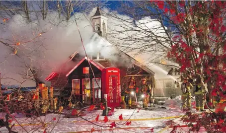  ?? PAT MCGRATH/OTTAWA CITIZEN ?? Crews had to pull down the bell tower of the heritage schoolhous­e for fear it would fall. The west Ottawa building housed the Cheshire Cat Pub.