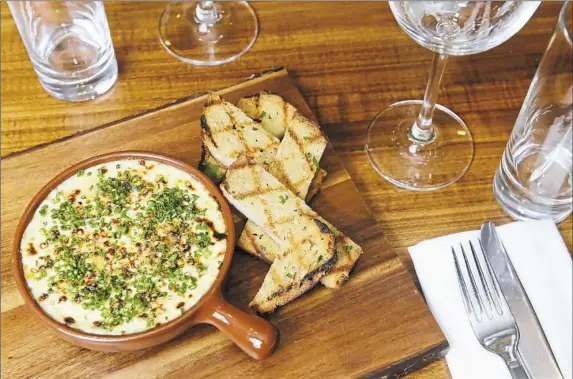  ?? Rebecca Droke/Post-Gazette ?? Salt cod with potato, garlic, chive, olive oil and sourdough toast at Acorn in Shadyside.