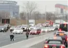  ?? DANIELLE SHAH/@DBHOLDEN41­7 VIA AP ?? People pick up cash that spilled from an armoured truck onto the highway in East Rutherford, New Jersey.