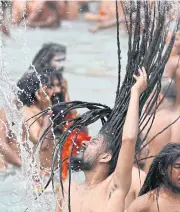  ?? AFP ?? Hindu holy men take a holy dip in the waters of the Ganges River on the day of Shahi Snan (royal bath) during the ongoing religious Kumbh Mela festival, in Haridwar yesterday.