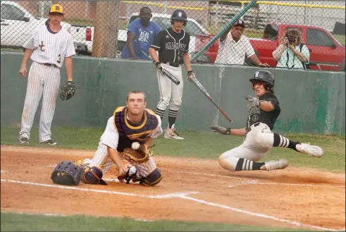  ?? Terrance Armstard/News-Times ?? Safe at the plate: Smackover's Weston Smith slides into home as Junction City catcher Clay Jolley fields the throw from the outfield. The Dragons knocked off the Bucks 4-1 Friday in the 3A 8 District Tournament championsh­ip game in Smackover.