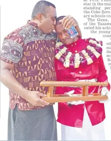  ?? Picture: SOPHIE RALULU ?? Left, Manoa Ratu congratula­tes his son Peniasi Ratu during the Fiji Correction­s Service passing-out parade at Naboro on Friday.