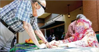  ?? PHOTOS BY MIGUEL MARTINEZ / FOR THE AJC ?? Hammond Glen Retirement Community resident Arthur Coppel greets Peggy Cobb at a party to celebrate her 105th birthday Friday.