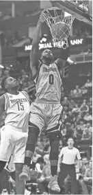  ?? ERIC CHRISTIAN SMITH/AP ?? Grizzlies forward JaMychal Green dunks as Rockets center Clint Capela looks on in the first half on Saturday in Houston.