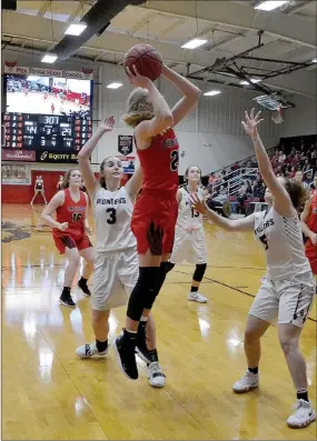  ?? TIMES photograph­s by Annette Beard ?? Sophomore Lady Blackhawk Blakelee Winn (No. 22) rose above the Pioneer defenders to take a shot Friday. Winn led the scoring with 21 points Friday.