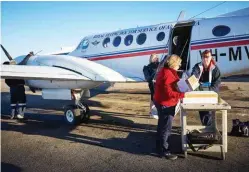  ??  ?? Mental-health team leader Vanessa Lathem (at plane door) and primary-health nurses Kristy James and Belinda Gentle load medical equipment before leaving the Broken Hill base for clinics.