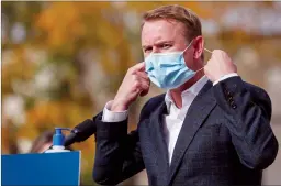  ?? CP FILE PHOTO ?? Minister of Health Tyler Shandro, removes his made-in-Calgary mask before speaking in Calgary on Oct. 7.