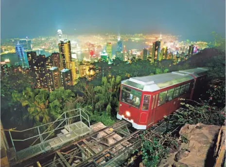  ?? PHOTOS BY HONG KONG TOURISM BOARD ?? Visitors can take a tram up to Victoria Peak, a mountain in the western half of Hong Kong Island, for views of the harbor.