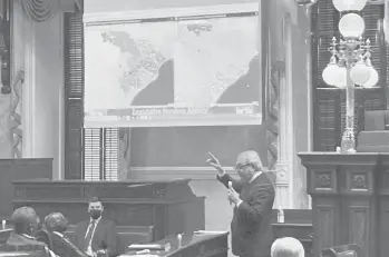  ?? JEFFREY COLLINS/AP ?? South Carolina state Sen. Dick Harpootlia­n, a Democrat, compares his proposed map of U.S. House districts drawn with 2020 U.S. Census data to a plan supported by Republican­s on Jan. 20 at the State House in Columbia, S.C.