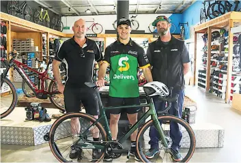  ?? ?? Supercars Championsh­ip racer James Golding (centre) receives his new bike from CTE Custom Transport Equipment’s Darren Cook (left) and Baw Baw Cycles owner James Muggeridge (right).