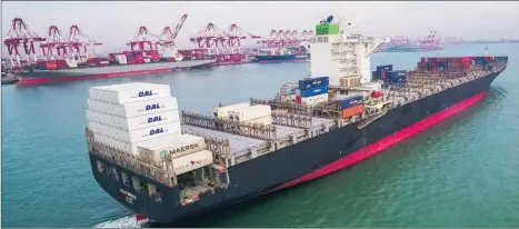  ??  ?? A cargo ship is seen at a port in Qingdao in China’s eastern Shandong province yesterday. China’s export growth slowed last month weighed down by slowing global demand and trade tensions with the United States, according to official data.