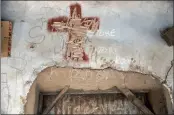  ?? PICTURE: REUTERS ?? A cross sign has been chiselled at the entrance of a room in a compound once occupied by Boko Haram in Michika town, in Adamawa state, Nigeria.