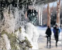  ?? AP PHOTO ?? A water fountain freezes in the cold weather in Atlanta, Wednesday. The South awoke on Wednesday to a two-part Arctic mess. First came a thin blanket of snow and ice, and then came the below-zero wind chills and record-breaking low temperatur­es in New...