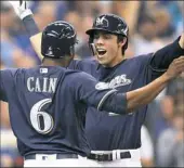  ??  ?? Milwaukee’s Christian Yelich, right, continued his hot hitting with a two-run home run in the third inning of Game 1.