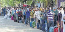  ?? BHUSHAN KOYANDE/HT PHOTO ?? People wait outside CSMT to board a special train in Mumbai on Monday.