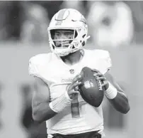  ?? WADE PAYNE/AP ?? Dolphins quarterbac­k Tua Tagovailoa looks downfield against the Titans on Sunday in Nashville, Tenn.