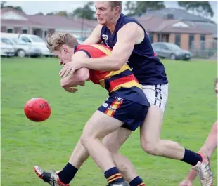  ??  ?? Longwarry’s Kane Oldham attempts to break the tackle of his Catani opponnent; Photograph­s: Amity Stephens.