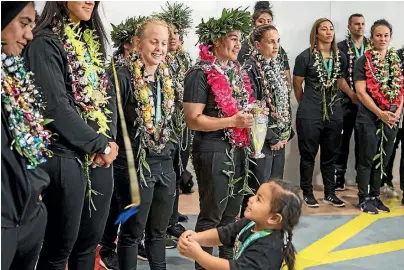  ?? LAWRENCE SMITH/STUFF ?? A young fan gets in on the celebratio­ns fo the Black Ferns at Auckland Airport yesterday.