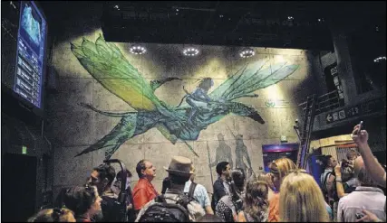  ?? JAY L. CLENDENIN/LOS ANGELES TIMES ?? Guests queue for Avatar Flight of Passage, which simulates the effect of riding a banshee, one of “Avatar’s” winged, dragon-like animals, inside Pandora.