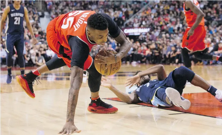  ?? — THE CANADIAN PRESS ?? The Raptors’ Delon Wright nabs the ball after clashing with the Grizzlies’ Wayne Selden on Sunday at the ACC. Wright had 15 points in Toronto’s 101-86 win.