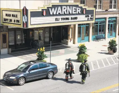  ?? John Murray / Contribute­d photo ?? Customers wait outside while the Torrington Fire Department investigat­es a gas leak at 79 Main St. The leak was discovered inside Mambo on the first floor, where it was contained. Firefighte­rs evacuated the building as a precaution and within 30 minutes it was cleared.