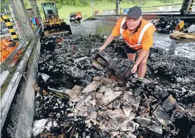  ?? Photo: ROBERT CHARLES/ FAIRFAX NZ ?? Rubble dump: Transfer Station manager Ian Coombe stands in rubbish set alight on Sunday night.