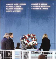  ?? JOE BURBANK/ORLANDO SENTINEL ?? The Sun illuminate­s the seven names of the astronauts killed in the 1986 Challenger disaster as a wreath is laid at the Space Mirror Memorial during a 35th anniversar­y commemorat­ion ceremony.