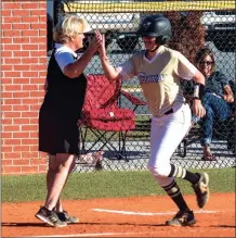  ?? TIM GODBEE / For the Calhoun Times ?? Calhoun’s Cassie Henderson (right) gets a high five from coach Diane Smith after a homer in Game 1 on Wednesday.