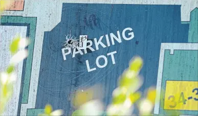  ?? CATHIE COWARD THE HAMILTON SPECTATOR ?? Bullet holes mark the sign to the public housing complex at 44 Martha St. following early morning gunfire. No one was injured in in the shooting at the building, located in the McQuesten neighbourh­ood near Parkdale Avenue North and Barton Street East.