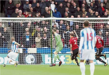  ?? — AP ?? Two up: Laurent Depoitre (left) scoring Huddersfie­ld’s second goal against Manchester United at the John Smith’s Stadium on Saturday.