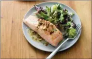  ?? DANIEL J. VAN ACKERE — AMERICA’S TEST KITCHEN VIA AP ?? This photo provided by America’s Test Kitchen shows Salmon with Almond Vinaigrett­e in Brookline, Mass. This recipe appears in “Cooking at Home with Bridget & Julia.”
