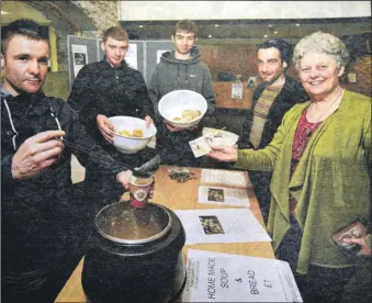  ?? Picture: The Write Image. ?? 2013: Martin Black, pictured left, and fellow students Kevin Sabui and Liam Johnstone of the Access to Further Education course at West Highland College UHI in Fort William served up soup and sandwiches to some very appreciati­ve diners to raise money for the soon-to-beopened Lochaber Food Bank. The students were inspired by a talk given by Lochaber Food Bank chairman John Penny, and decided to raise money to help. The initiative raised £70, earning the lads praise and heartfelt thanks from Sandra Casey, right, a Lochaber Food Bank trustee and lecturer at the college.