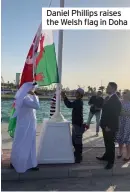  ?? ?? Daniel Phillips raises the Welsh flag in Doha