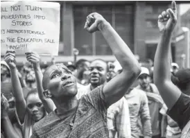  ??  ?? Students protest outside the parliament in Cape Town on Wednesday [Reuters