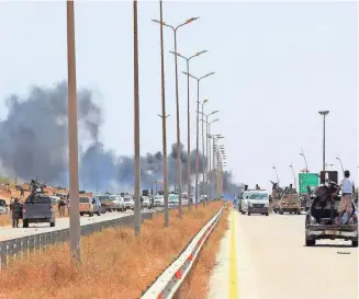  ??  ?? Smoke billows at the entrance of Sirte as forces loyal to Libya’s UN-backed unity government advances.