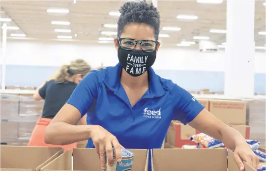  ??  ?? Feed Nova Scotia staff member Kate Sunabacka sorts food for distributi­on to those who are experienci­ng food insecurity at a warehouse in Dartmouth in August.