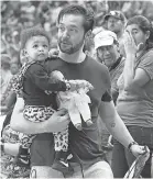  ??  ?? Serena Williams’ husband, Alexis Ohanian, carries Alexis Olympia, who is holding Qai Qai. GETTY IMAGES