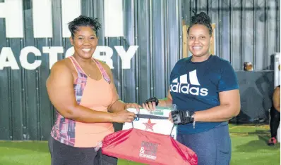  ?? ?? Red Stripe Brand and Corporate PR Manager, Stacy-Ann Williams-Smith (left) shares in Cheers to a Dry Lent Challenge third-place winner Samantha Brown’s joy as she collects her prize following an intense 40-day focus on wellness.