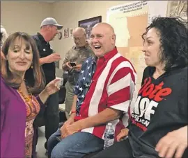  ?? David Montero Los Angeles Times ?? “THIS IS American history,” Dennis Hof said of his victory. He celebrated with Heidi Fleiss, right, and others at Nye County GOP headquarte­rs in Pahrump.