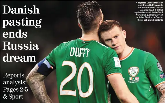  ??  ?? A dejected James McClean and Shane Duffy console one another after Ireland crashed to a 5-1 defeat against Denmark in the 2018 World Cup qualifier play-off at Aviva Stadium in Dublin. Photo: Seb Daly/Sportsfile