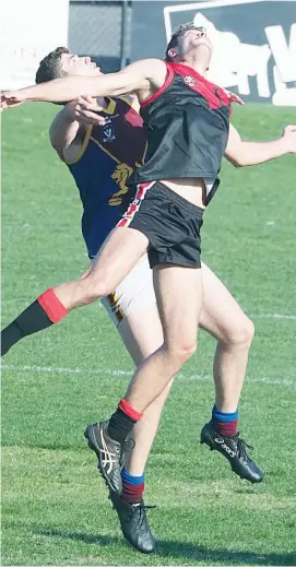  ??  ?? Key Warragul backman Matt Rennie gets forced under the ball by his Moe opponent in this marking contest. Rennie was later forced from the ground with a knee injury robbing the Gulls of his leadership in that part of the ground and forcing rearrangem­ent...