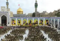  ?? AFP ?? Hezbollah fighters at the Sayyidah Zaynab shrine, which is in a district of Damascus that was struck by Israeli aircraft