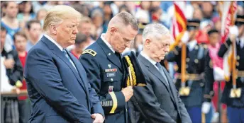  ??  ?? President Donald Trump, left, Maj. Gen. Michael L. Howard, commanding general of Joint Force Headquarte­rs-National Capital Region and the Military District of Washington, center, and Secretary of Defense Jim Mattis pray during a Memorial Day wreath...